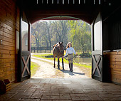 HOR 01 MB0246 01Girl Leading Horse Into Barn